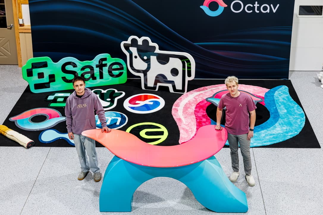 Atlas team with custom event signage, branded rugs, and sculptural furniture for Denver conference